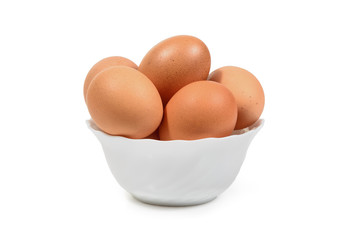 Brown eggs in white porcelan bowl isolated. Clipping path