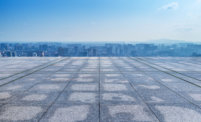 empty marble floor with cityscape and skyline in cloud sky 