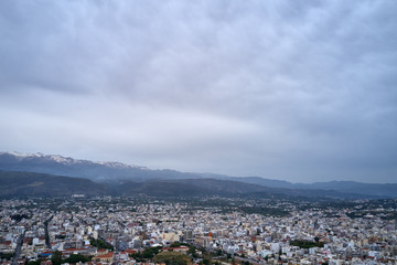 Panoramic aerial view from above of the city of Chania, Crete island, Greece with white mountains, beautiful venetian town Chania in Crete island. Chania, Crete, Greece.