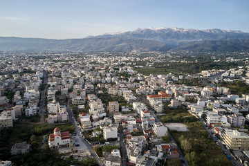 Panoramic aerial view from above of the city of Chania, Crete island, Greece with white mountains, beautiful venetian town Chania in Crete island. Chania, Crete, Greece.