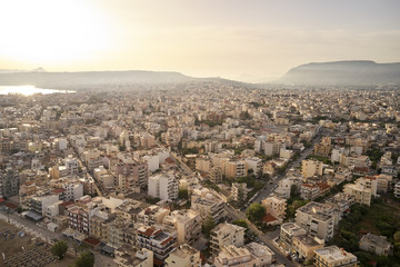 Panoramic aerial view from above of the city of Chania, Crete island, Greece with white mountains, beautiful venetian town Chania in Crete island. Chania, Crete, Greece.
