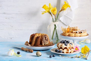 Easter festive dessert table with various of cakes,  pancakes, waffles and sweets.