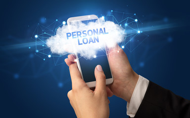 Female hand touching smartphone with PERSONAL LOAN inscription, cloud business concept