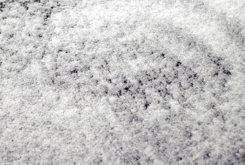 Abstract wallpaper design of white color shiny snow dust powder isolated on black background