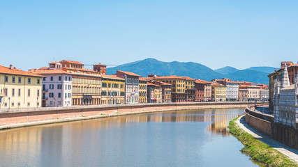 Views of the Arno river through the city of Pisa, Italy from the Solferino Bridge
