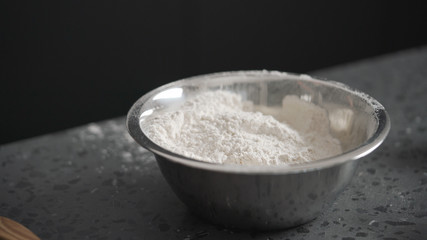 dry ingredients with flour in steel bowl on concrete countertop