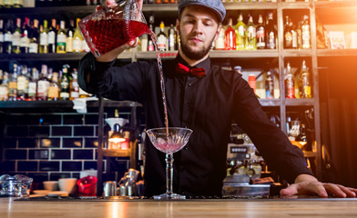 Bartender is making cocktail at bar counter. Fresh cocktails. 