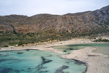 Amazing aerial drone top panoramic view on the famous Balos beach in Balos lagoon and pirate island Gramvousa. Place of the confluence of three seas. Balos beach, Chania. Crete island. Greece. Europe.