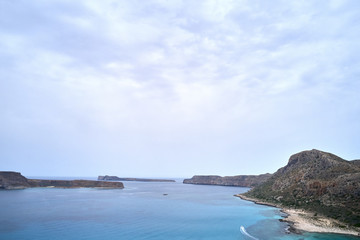 Amazing aerial drone top panoramic view on the famous Balos beach in Balos lagoon and pirate island Gramvousa. Place of the confluence of three seas. Balos beach, Chania. Crete island. Greece. Europe.