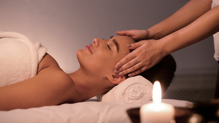 Obraz na płótnie Canvas Spa treatment. Young woman enjoying face massage