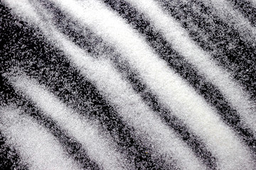 Abstract wallpaper stripe design of white color shiny snow dust powder isolated on black background