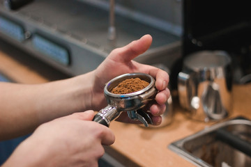 Holder with coffee in male hands.
