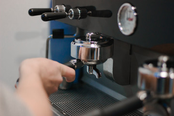 Fototapeta na wymiar The process of making coffee. Barista and coffee machine