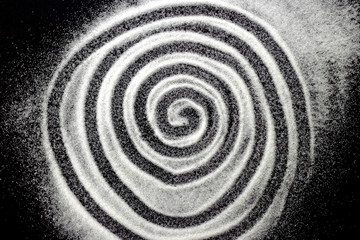 Fototapeta na wymiar Abstract circles labyrinth design of white shiny snow dust powder isolated on black background