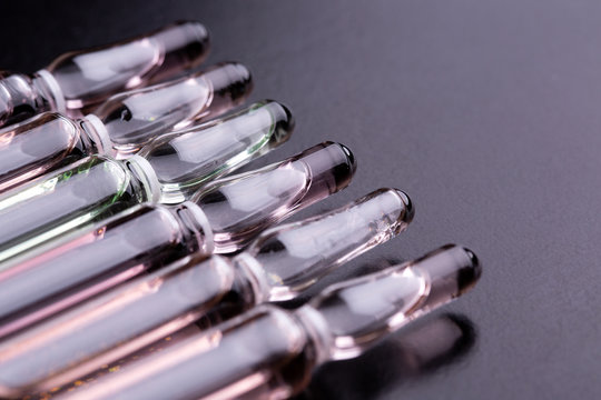 Ampoules on the table. Glass ampoules close up.