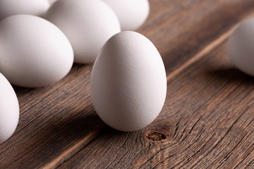 Eggs on the table close-up. Fresh raw eggs on a wooden table. Set of white chicken eggs.