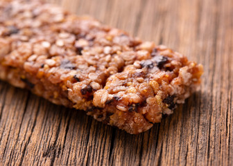 Sweet fitness bar on a wooden table. Fitness bar on a wooden background close-up.