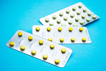 pills in blister pack on blue background