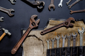 Vintage tool kit for repair and reconstruction at home lie on a black background
