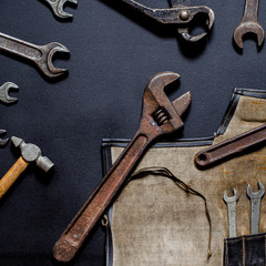 Vintage tool kit for repair and reconstruction at home lie on a black background