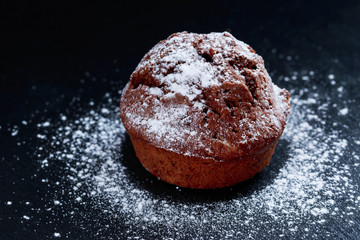 chocolate muffin with powdered sugar