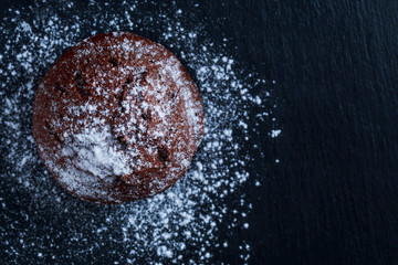 chocolate muffin with powdered sugar