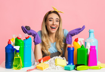 Blonde housewife in gloves and apron. House cleaning concept