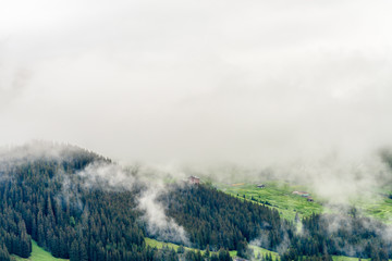 The Swiss Alps at Murren, Switzerland. Jungfrau Region. Tops of the mountains in fog and clouds.