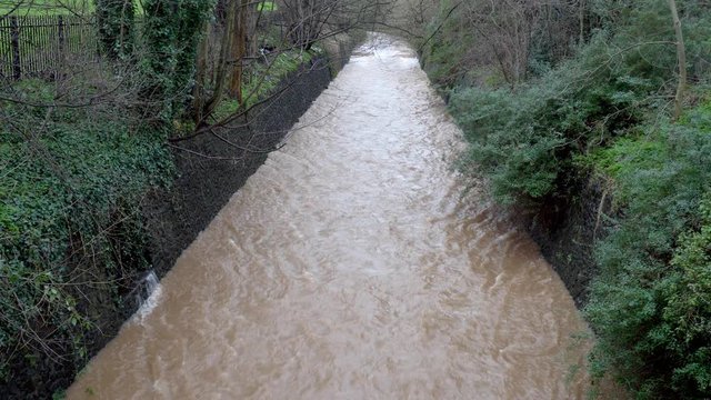 Flood water.  River Rea in Birmingham in full spate after heavy rainfall.