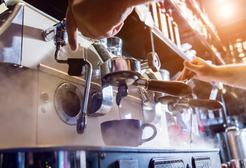 The bartender makes the coffee, cappuccino, cocoa, drink at the bar. 