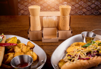 Hotdogs and French fries on a dishes. Fast food meal. Restaurant.