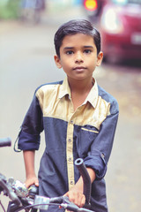 Obraz na płótnie Canvas Indian little boy enjoying the cycle ride