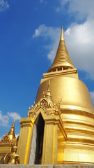 Fototapeta premium Thailand Beautiful Golden Pagoda with blue sky background at Wat Pra Kaew (Temple of the Emerald Buddha).
