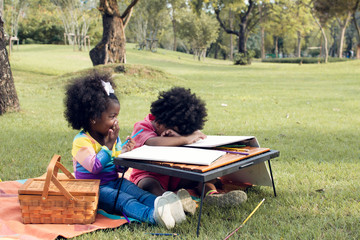 Little african boy and girl playing in backyard
