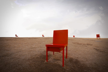 Red chairs on yellow grassland