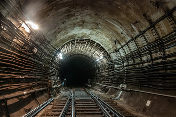 The connection of a reinforced concrete tunnel with a cast-iron tunnel.The light is on.The...