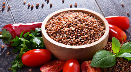 Bowl of buckwheat kasha on wooden table