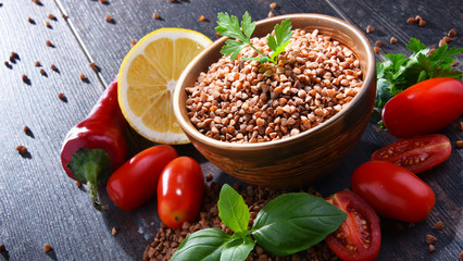 Bowl of buckwheat kasha on wooden table