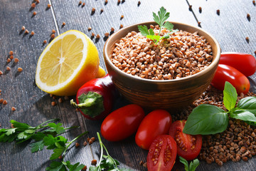 Bowl of buckwheat kasha on wooden table