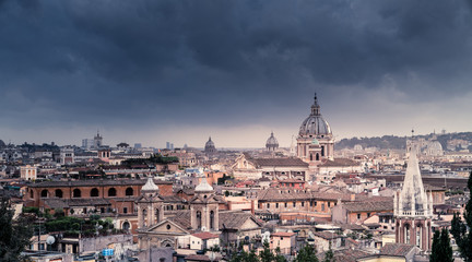 Fototapeta na wymiar Rooftops of Rome under dramatic sky