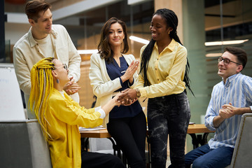 two competitive companies negotating a sale , women are greeting ech other in the meeting, nice to...