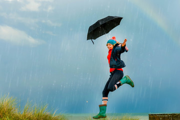 young woman in storm with her umbrella