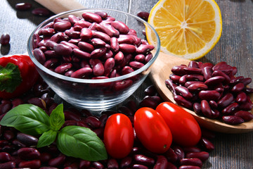 Composition with bowl of kidney bean on wooden table