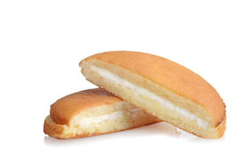 two slices of vanilla sponge cake with cream filling