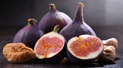 Composition with fresh and dried figs on wooden table