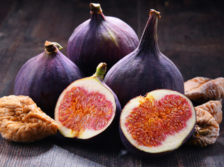 Composition with fresh and dried figs on wooden table