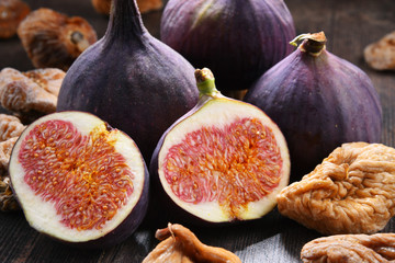 Composition with fresh and dried figs on wooden table