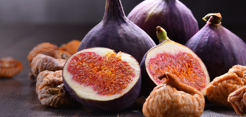 Composition with fresh and dried figs on wooden table