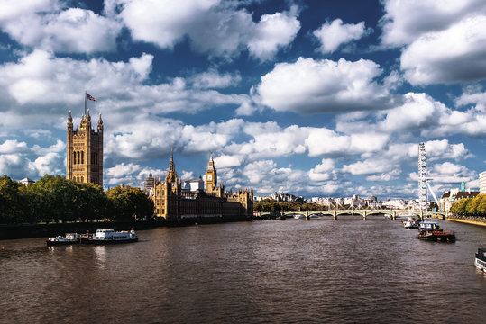 Beautiful cloudy sky with Houses of Parliament and London eye in London, UK