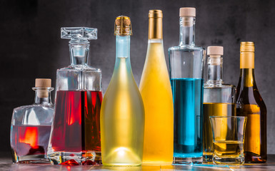 Carafe and bottles of assorted alcoholic beverages.
